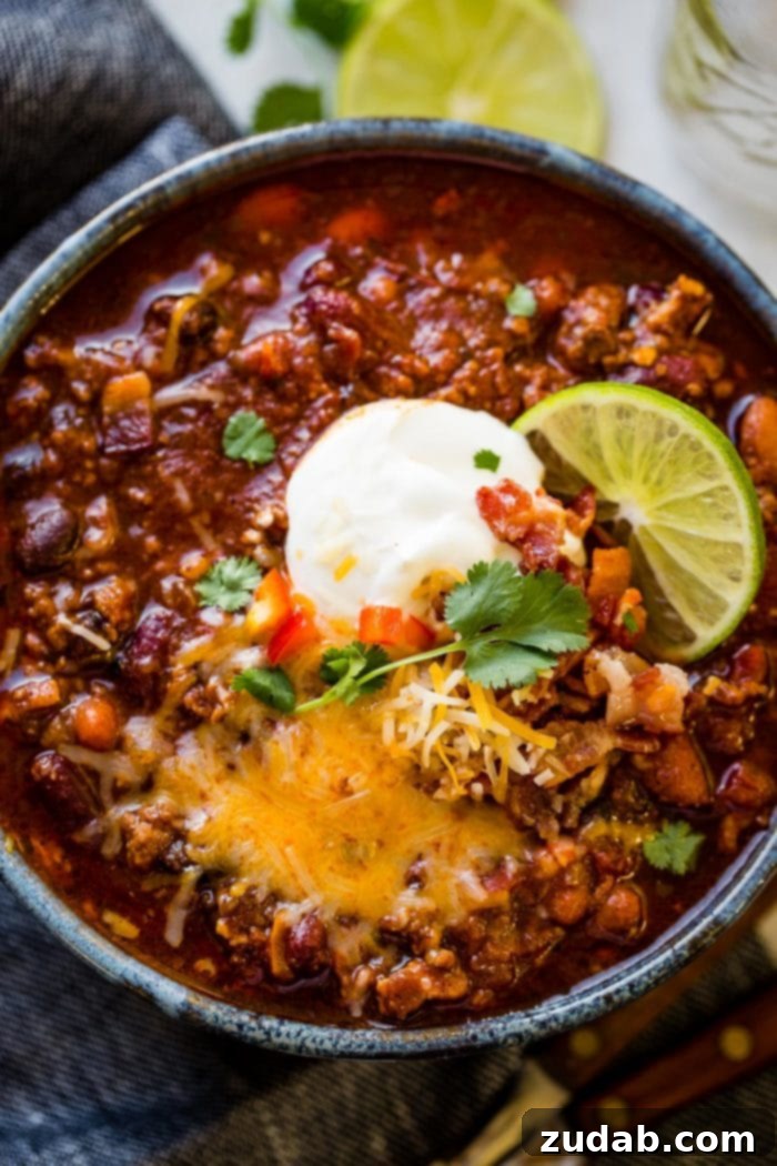 Weekly Meal Plan October 30 to November 5 4 A steaming bowl of award-winning Instant Pot Chili, garnished with shredded cheese and fresh cilantro, promising rich and comforting flavors.