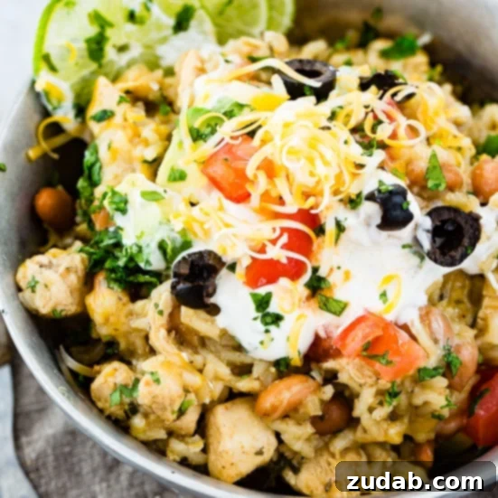Our Weekly Meal Plan: April 29 - May 5 4 Delicious Instant Pot cilantro lime chicken burrito bowls, generously topped with creamy sour cream, vibrant fresh tomatoes, aromatic cilantro, briny olives, and an abundance of melted gooey cheese.
