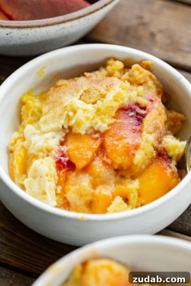 Weekly Meal Plan for August 19 to 25 9 A delectable serving of warm, juicy peach cobbler, crowned with a golden, crumbly cake mix topping, invitingly presented.