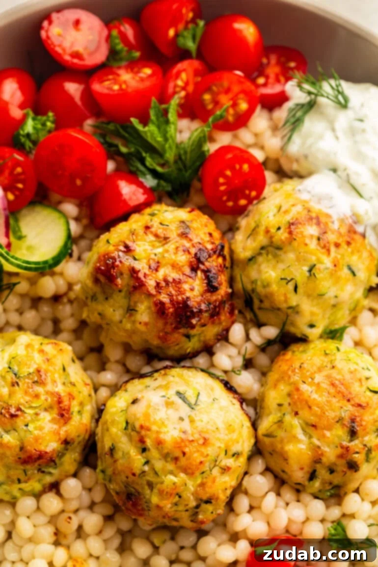 Herb-Infused Greek Chicken Meatballs 3 Golden-baked Greek Chicken Meatballs on a bed of pearl couscous