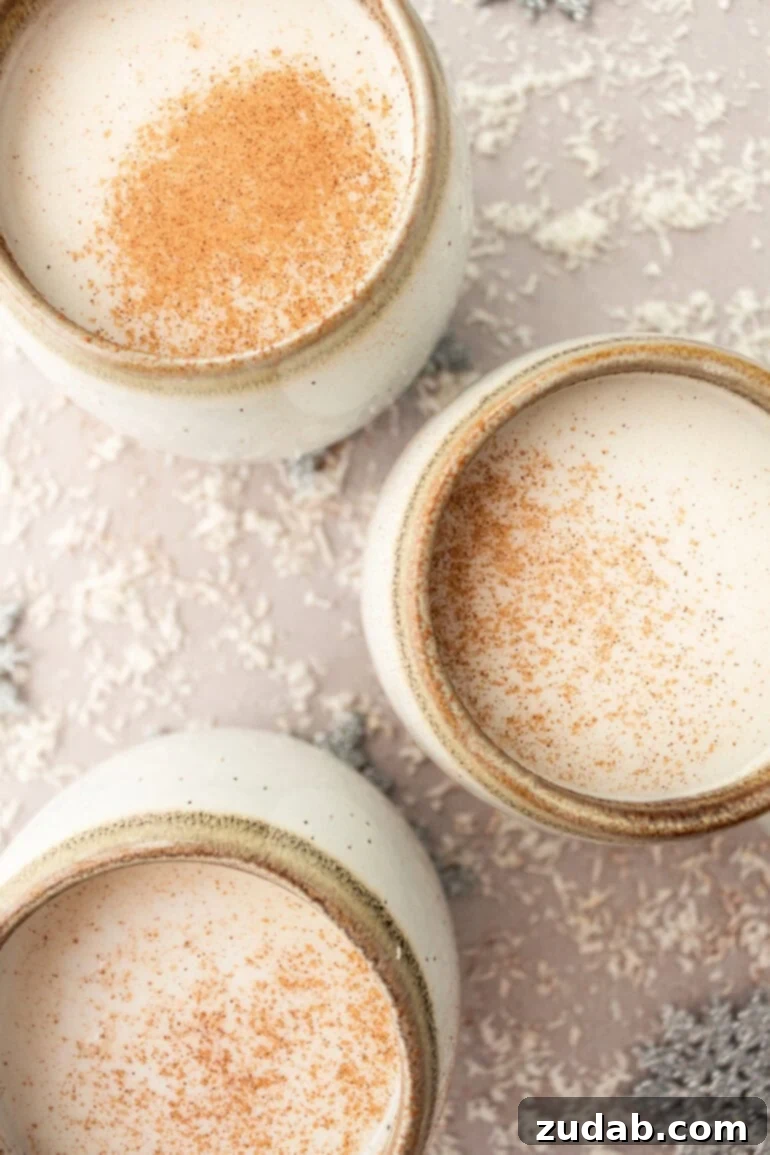 Snowman Soup: A Hug in a Mug for the Holidays 11 Several mugs full of warm vanilla milk topped with sprinkled cinnamon