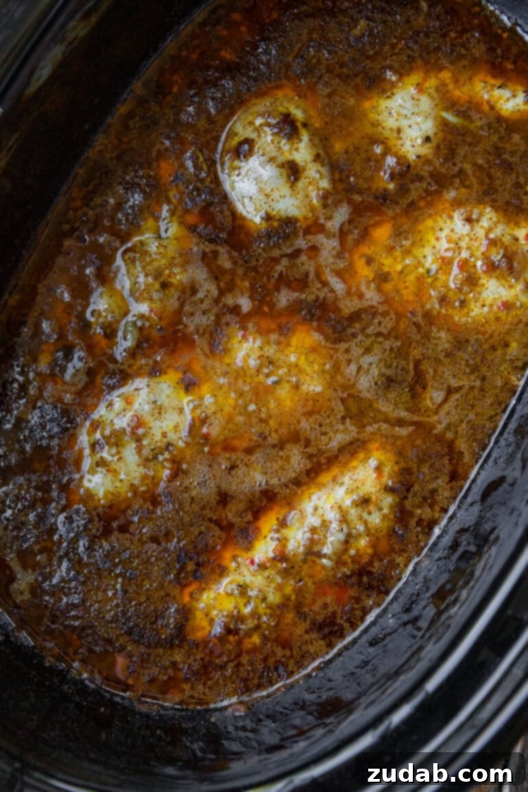 Cafe Rio's Famous Chicken: A Culinary Adventure 5 Chicken breasts cooking in a crockpot