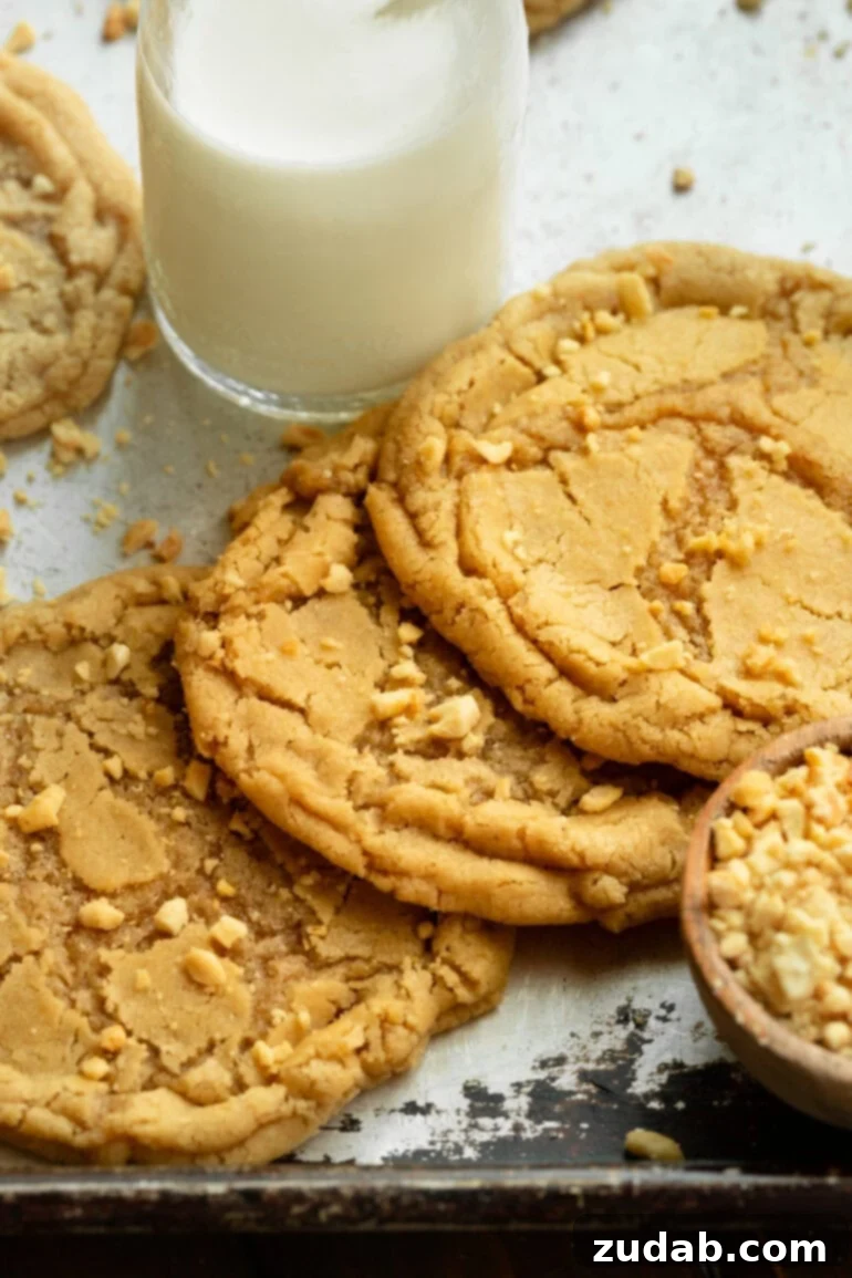 Bakery-Style Peanut Butter Dream Cookies 4 Several large chewy peanut butter cookies with a glass of milk.