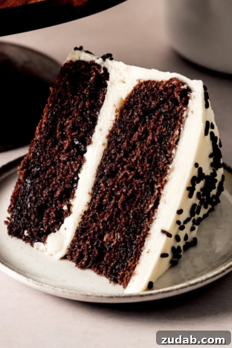 From Box to Bliss: Elevating Simple Chocolate Cake 21 A slice of two-layer chocolate cake with vanilla buttercream frosting topped with chocolate sprinkles.