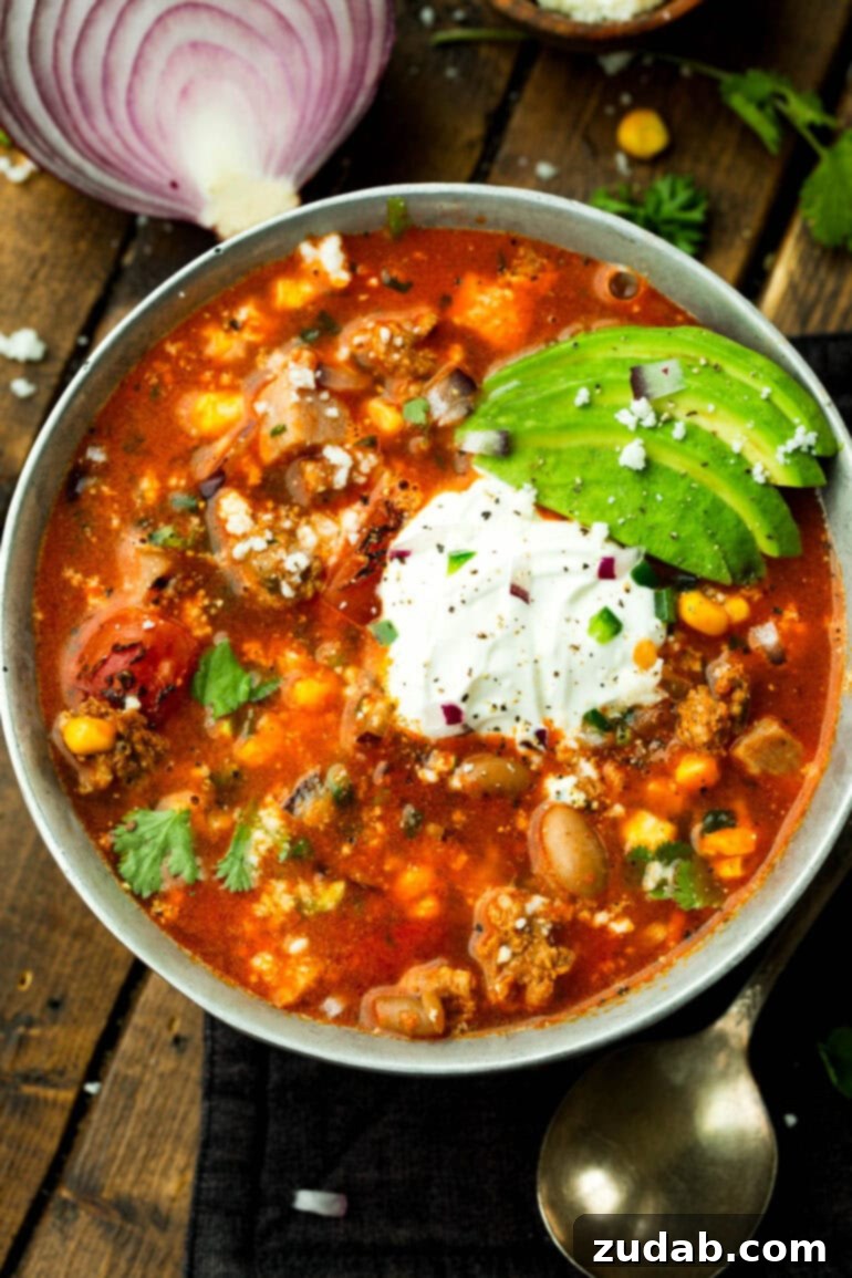Cowboy Pinto Bean Soup Recipe 5 A large bowl of charro bean soup with various toppings