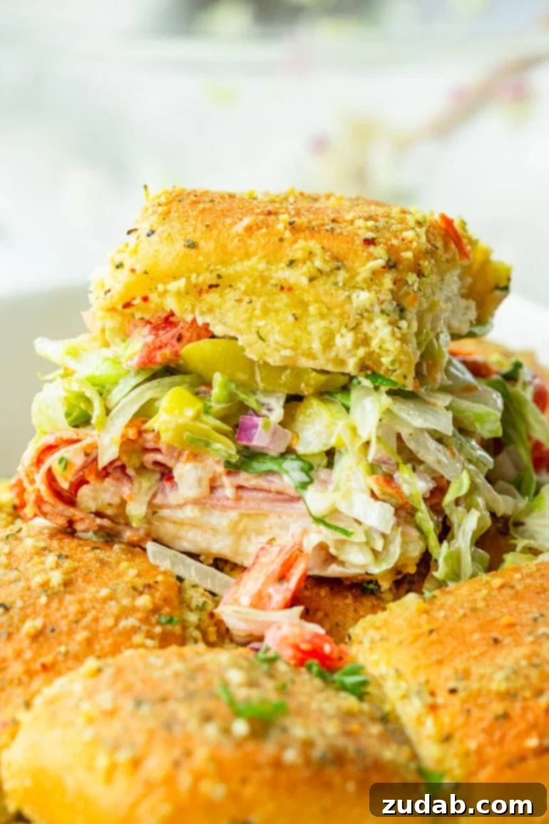 Super Bowl Slider Showdown: An Italian Twist 2 Italian slider loaded with lettuce, tomatoes, Italian meats, and creamy Italian dressing