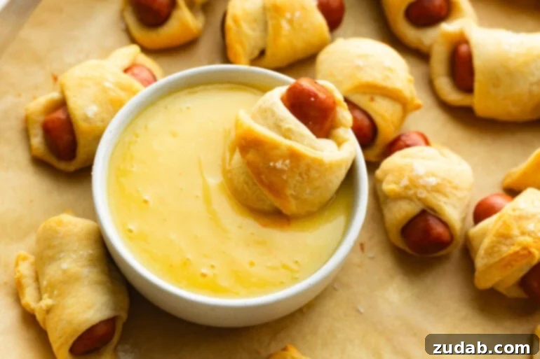 Pigs in a Blanket: A Savory Bite-Sized Delight 7 Lil smokies pig in a blanket next to honey mustard dip