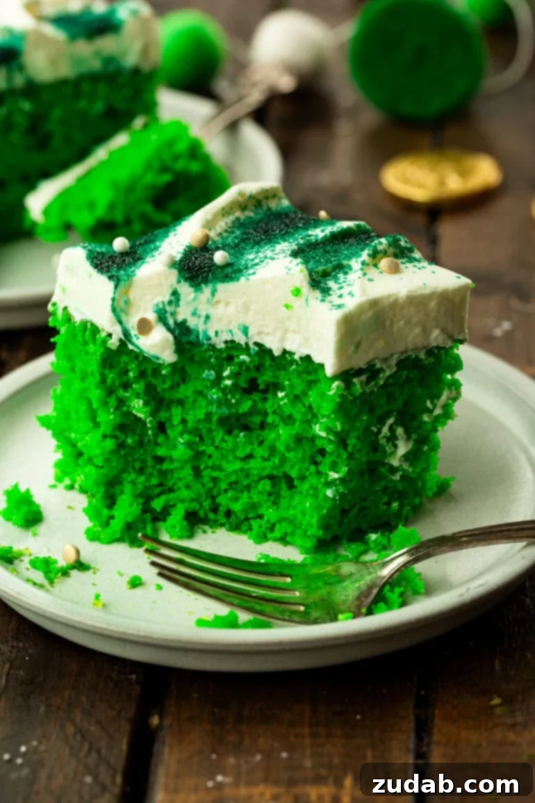 Luck o' the Irish Poke Cake 2 Lime Jello Poke Cake with White Frosting and Green Sprinkles