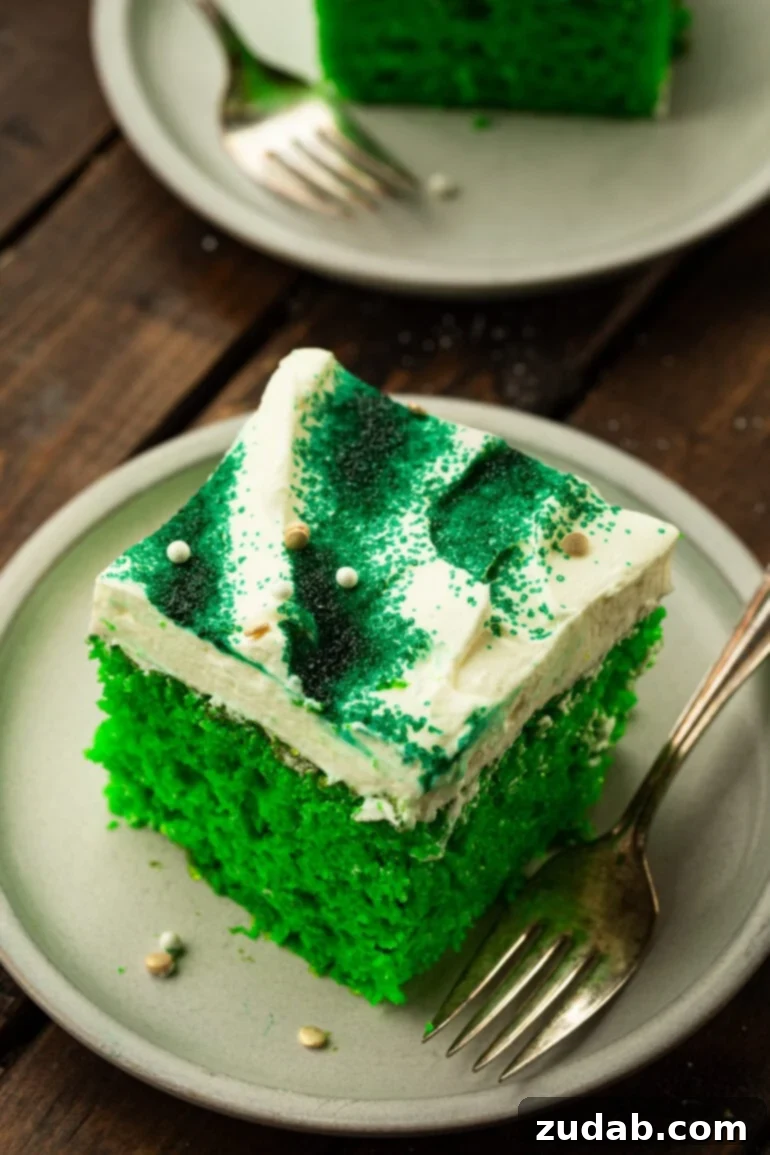 Luck o' the Irish Poke Cake 5 Lime Cake with Cream Cheese Frosting on a Dessert Plate