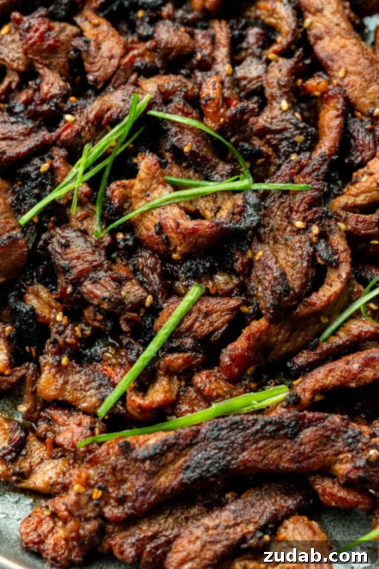 Effortless Bulgogi: A Korean BBQ Delight You Can Make At Home 3 Delicious strips of beef bulgogi with sesame seeds and green onions
