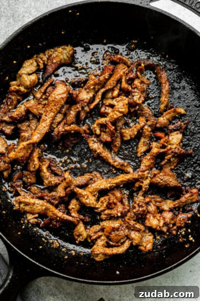 Effortless Bulgogi: A Korean BBQ Delight You Can Make At Home 5 Thin slices of beef being cooked in a skillet