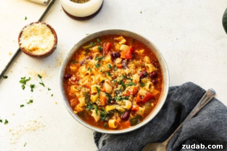 Grandma's Secret Garden Minestrone 5 A cozy bowl of homemade Minestrone soup, garnished with parsley and served with rustic bread.