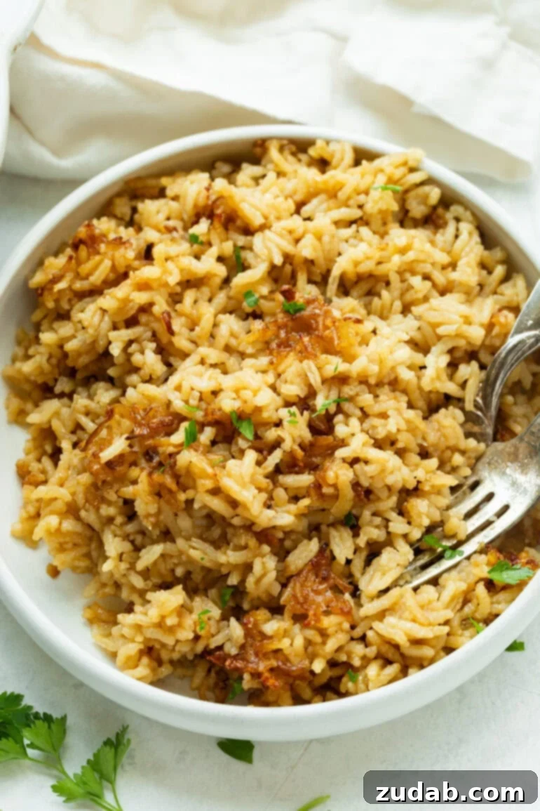 Golden Onion Butter Rice 2 Creamy, comforting rice with a deep savory flavor served in a cozy bowl.