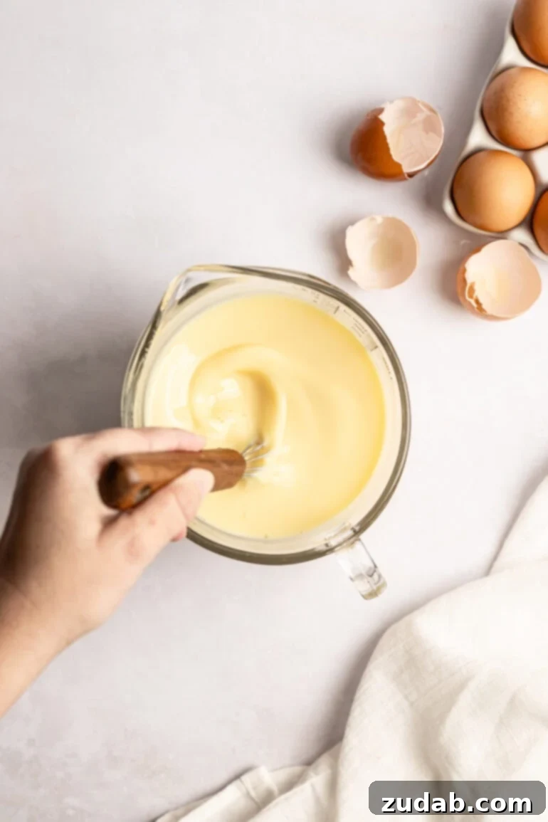 Step-by-step image of mixing wet ingredients in a separate bowl.
