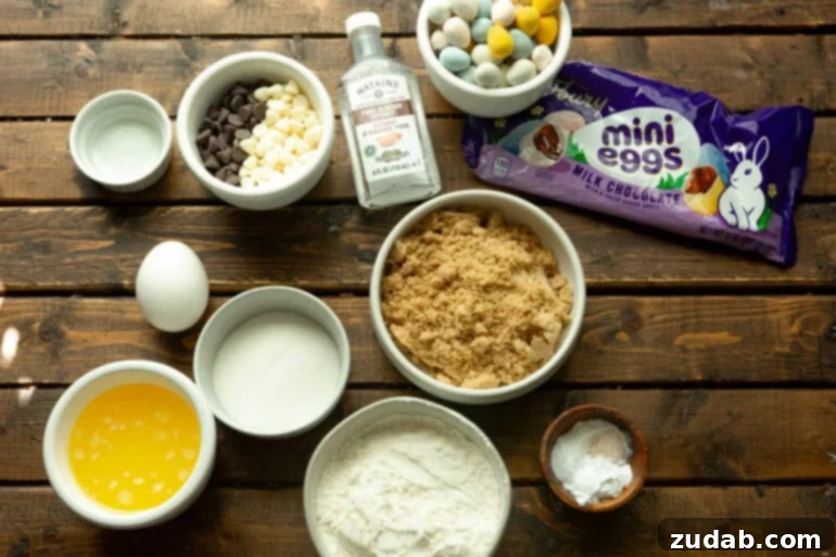 Ultimate Easter Cadbury Mini Egg Blondies 3 Ingredients for an easter dessert laid out on a counter: butter, sugar, flour, egg, and Mini Eggs.