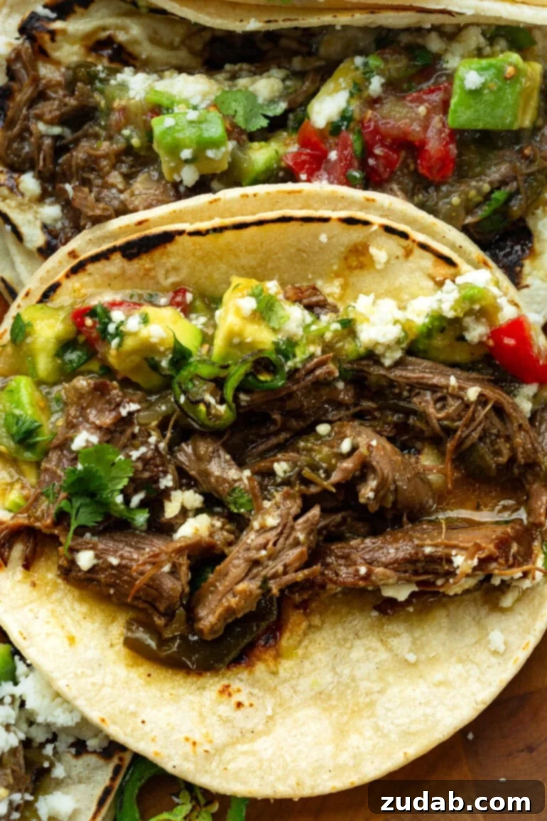 Fall-Apart Poblano Beef Tacos from One Pot 4 Overhead shot of shredded beef tacos loaded with juicy braised beef, roasted poblanos, fresh salsa, and crumbled queso fresco.