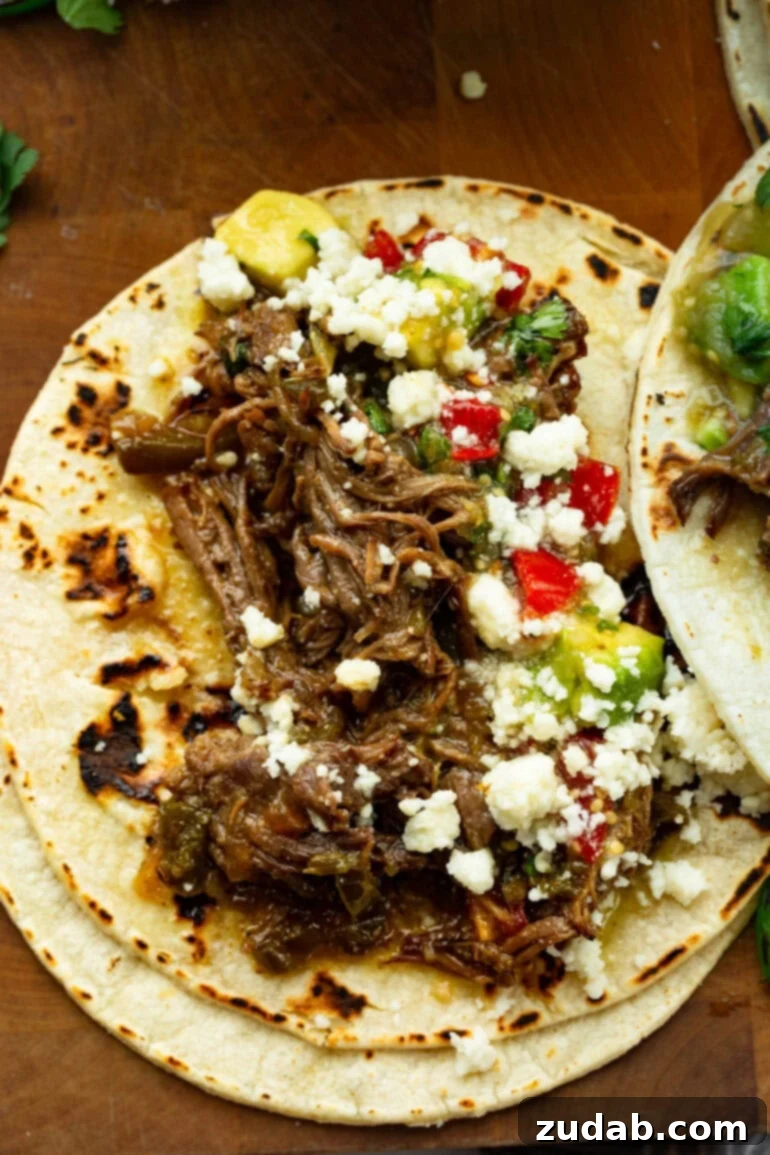 Fall-Apart Poblano Beef Tacos from One Pot 5 Shredded poblano braised beef tucked into a warm corn tortilla and topped with avocado, salsa, queso fresco, and fresh cilantro.