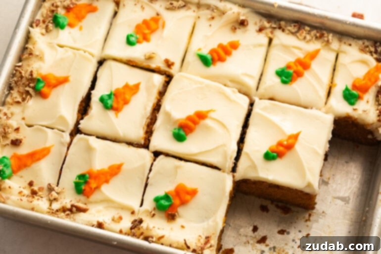 Effortless Carrot Cake: The Baby Food Secret 9 a whole carrot cake topped with cream cheese frosting cut into individual slices with each piece topped with a little piped carrot