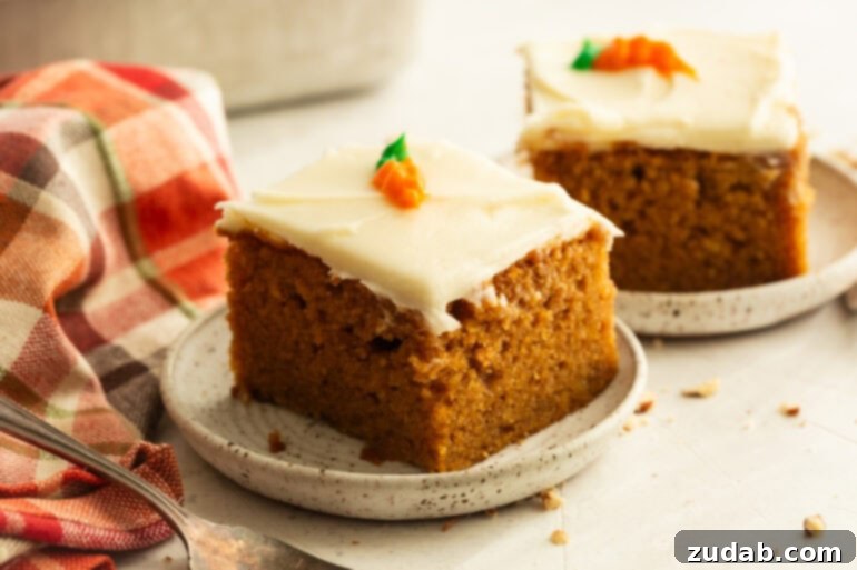 Effortless Carrot Cake: The Baby Food Secret 10 a slice of moist carrot cake on a small dessert plate topped with cream cheese frosting on top