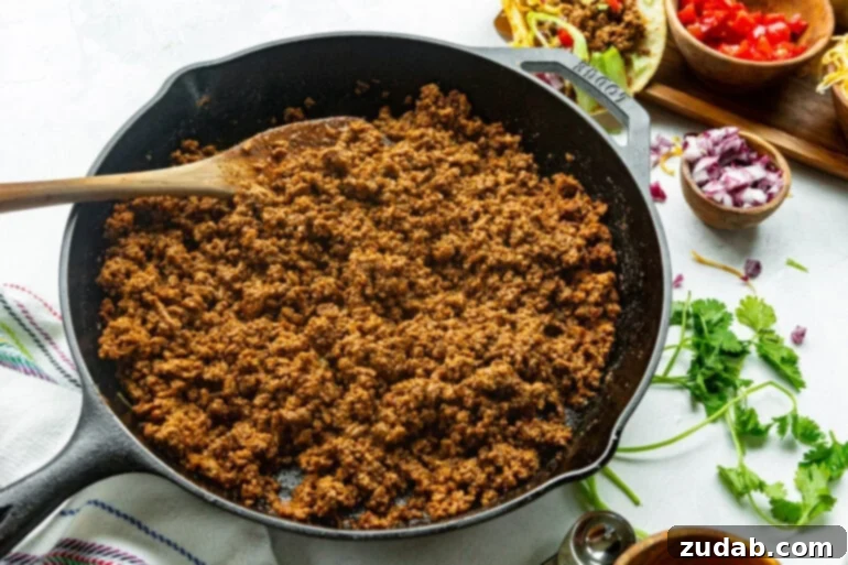 Speedy Weeknight Beef Tacos 3 a cast iron skillet full of cooked seasoned ground beef ready for tacos