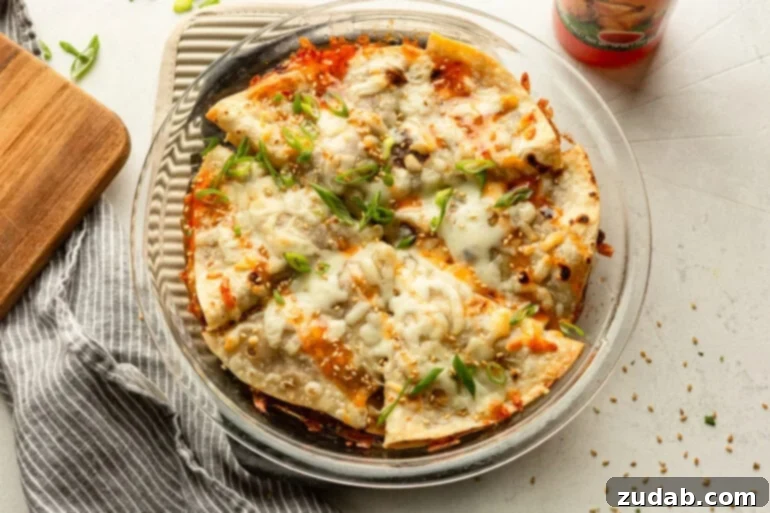 Crispy Korean Beef Pockets Speedy Weeknight Delight 3 a circular casserole dish full of 6 crunchy korean beef pockets topped with melted cheese and diced green onions