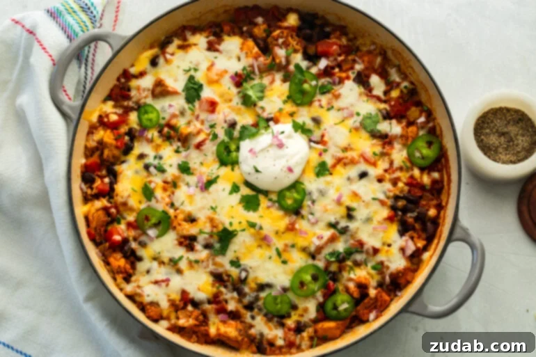 Chicken taco casserole fresh from the oven in an enameled pan, viewed from above.