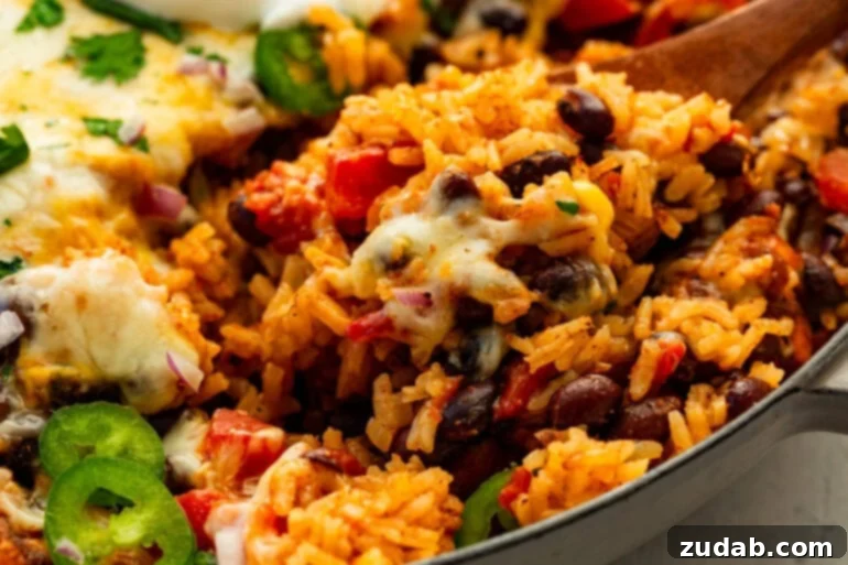 Chicken taco casserole baked until bubbly in an enameled pan, close-up angle