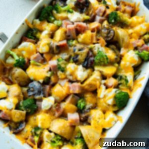 a photo of large white baking dish filled with hearty broccoli potato ham casserole
