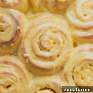 Bright and zesty Orange Sweet Rolls, a cheerful addition to any Easter brunch, glistening with glaze.