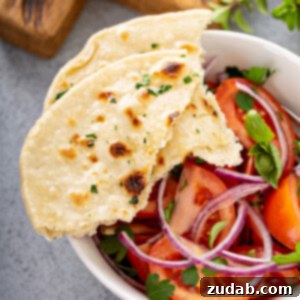 Freshly baked unleavened bread, simple and symbolic, resting on a serving board.