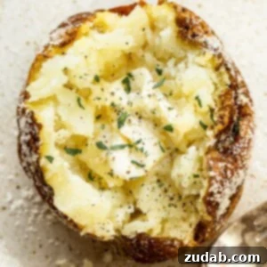 Crispy skin baked potatoes, fluffy on the inside, showing off their perfectly browned exteriors.