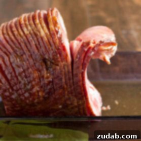 A step-by-step guide to carving a spiral ham, ensuring perfect slices every time.