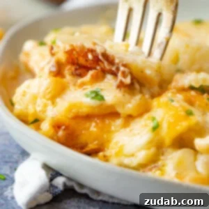 A golden-brown cheesy potato casserole, bubbling hot from the oven and ready to be served as an indulgent side dish.