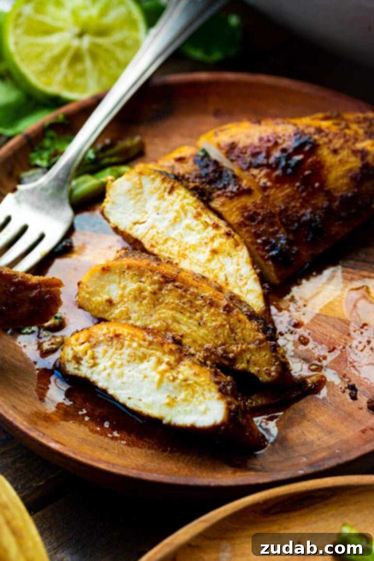 Easy Authentic Cinco de Mayo Recipes for Your Fiesta 20 a photo of a pan seared chicken breast that has had a few slices removed to show the inside of the meat.