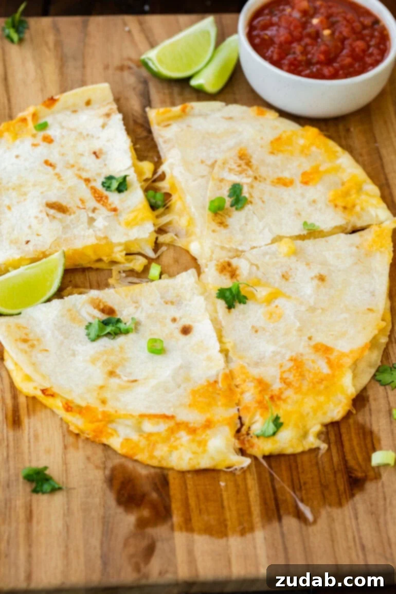 Easy Authentic Cinco de Mayo Recipes for Your Fiesta 34 a photo of a cheese quesadilla made with a golden flour tortilla and cut into quarters