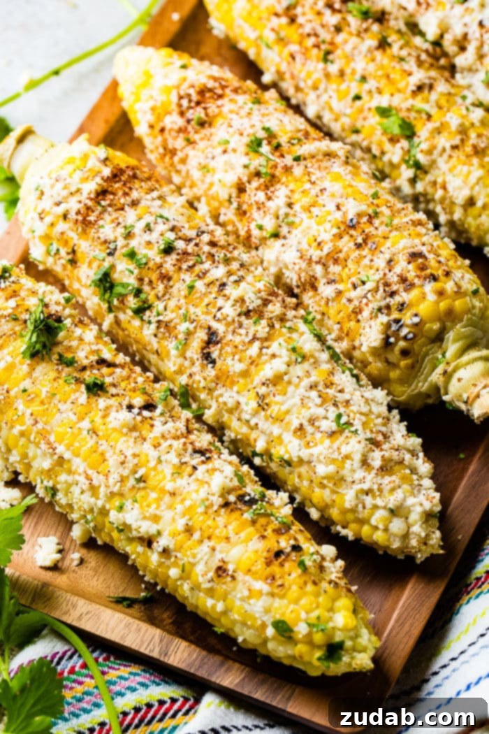Easy Authentic Cinco de Mayo Recipes for Your Fiesta 46 A photo of several cobs of elote mexican street corn lathered in cotija cheese and seasonings.