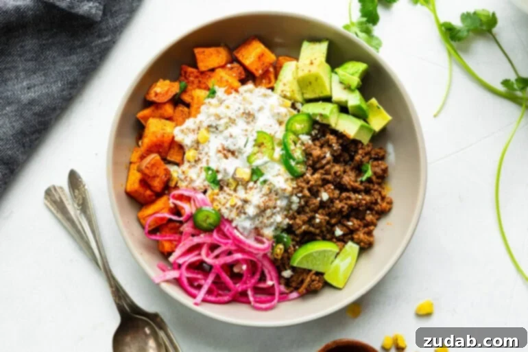 Street Corn Ground Beef Sweet Potato Power Bowl 2 A ground beef sweet potato bowl topped with creamy elote street corn, fresh avocado chunks, and tangy pickled red onions.