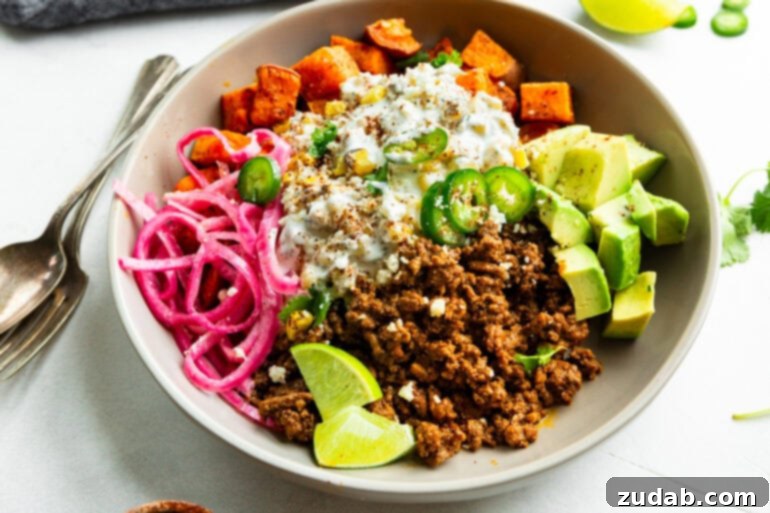Street Corn Ground Beef Sweet Potato Power Bowl 5 A vibrant ground beef sweet potato bowl featuring creamy elote, bright pickled red onions, and fresh avocado, showcasing its delicious and healthy appeal.