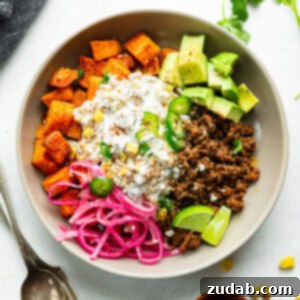 a ground beef sweet potato bowl with elote street corn, avocado chunks and picked red onions