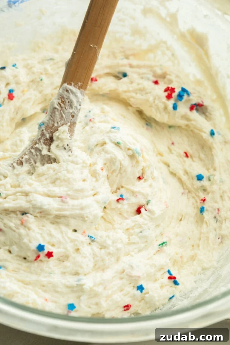 Red White and Blue Funfetti Dip Recipe for Patriotic Parties 5 Close-up of creamy Funfetti Dip topped with red white and blue sprinkles.