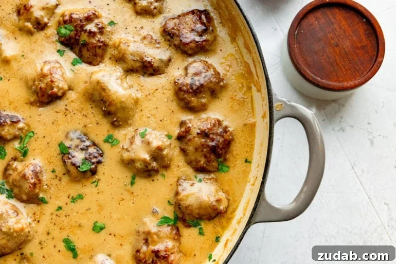 Classic Swedish Meatballs with Creamy Gravy 4 a large dutch oven full of Swedish meatballs simmering in a creamy gravy